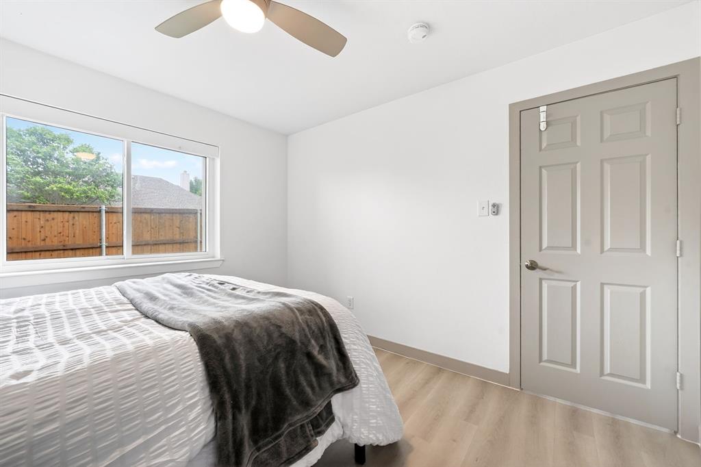 7503 Vista Ridge Lane Sachse, TX 75048 - Photo 28 of 33 Bedroom featuring light-colored flooring, a window providing natural light, and a ceiling fan with an integrated light fixture