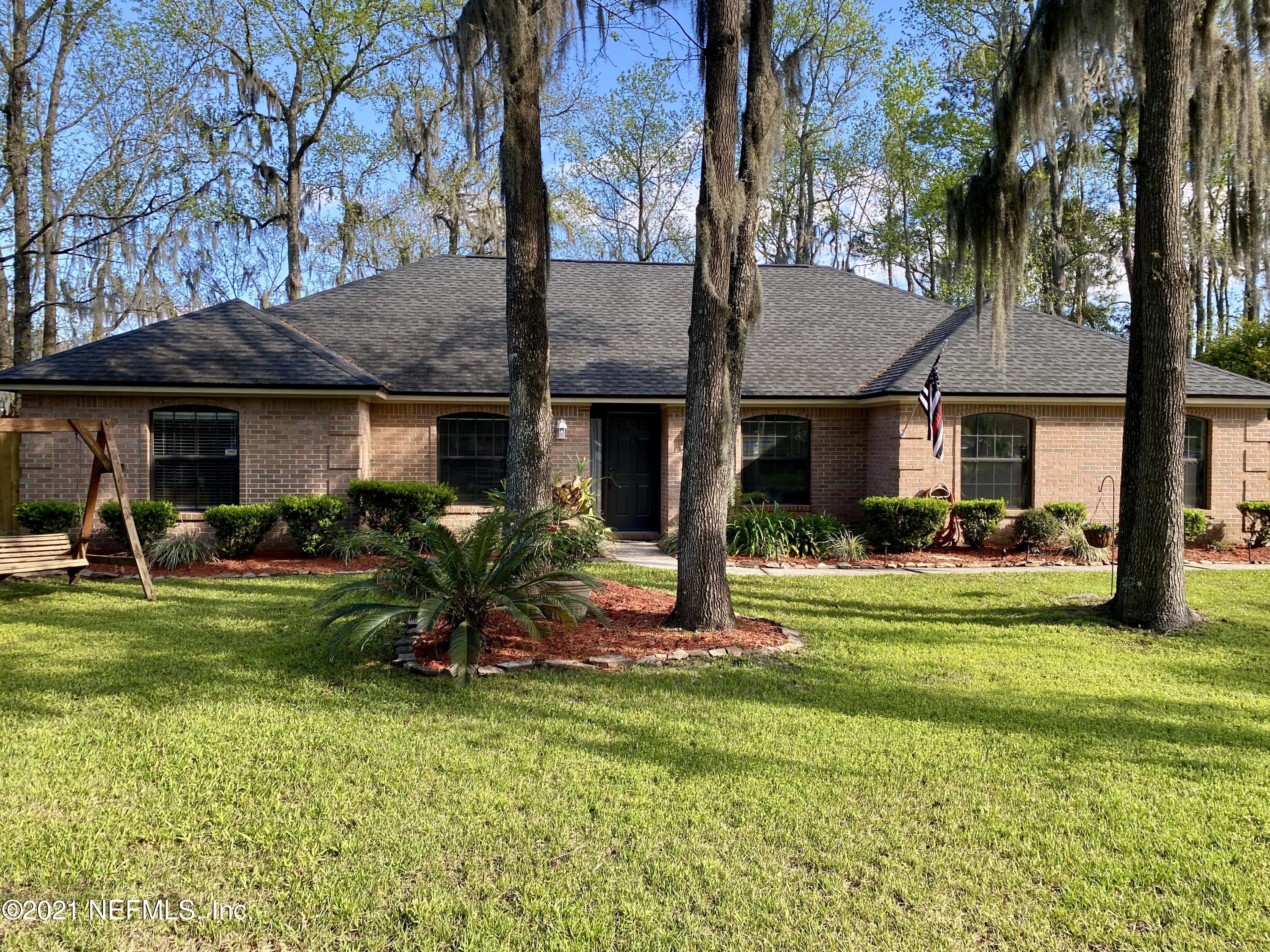 3021 Nautilus Road Middleburg, FL 32068 - Photo 1 of 25 a view of a house with backyard and sitting area