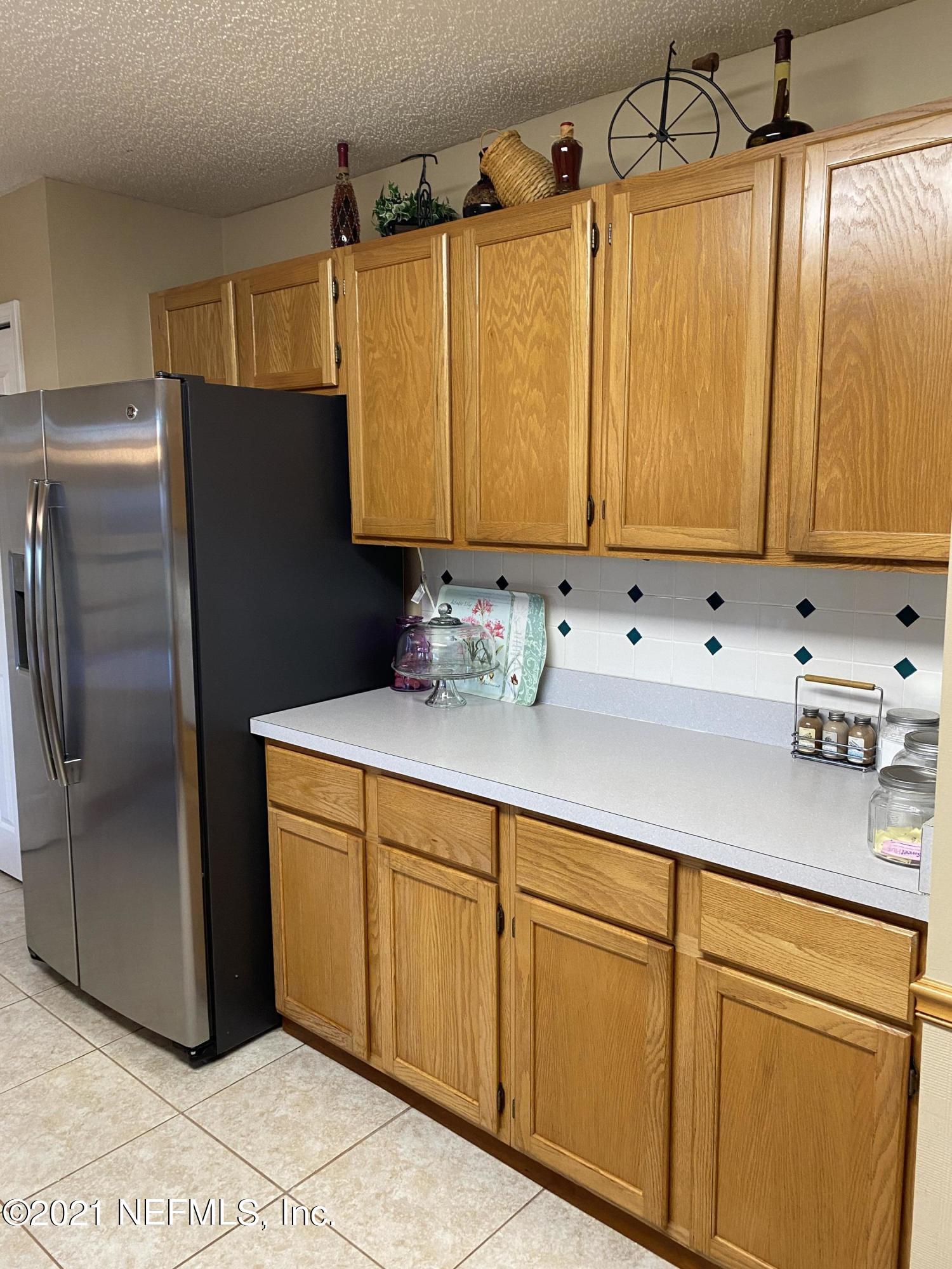 3021 Nautilus Road Middleburg, FL 32068 - Photo 15 of 25 a kitchen with stainless steel appliances a refrigerator a sink and cabinets