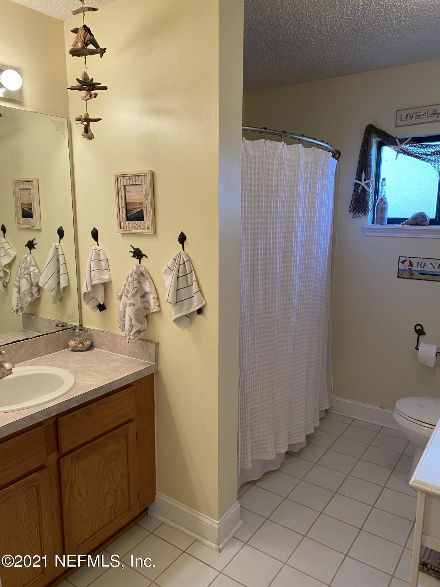 3021 Nautilus Road Middleburg, FL 32068 - Photo 20 of 25 a bathroom with a sink a toilet and mirror