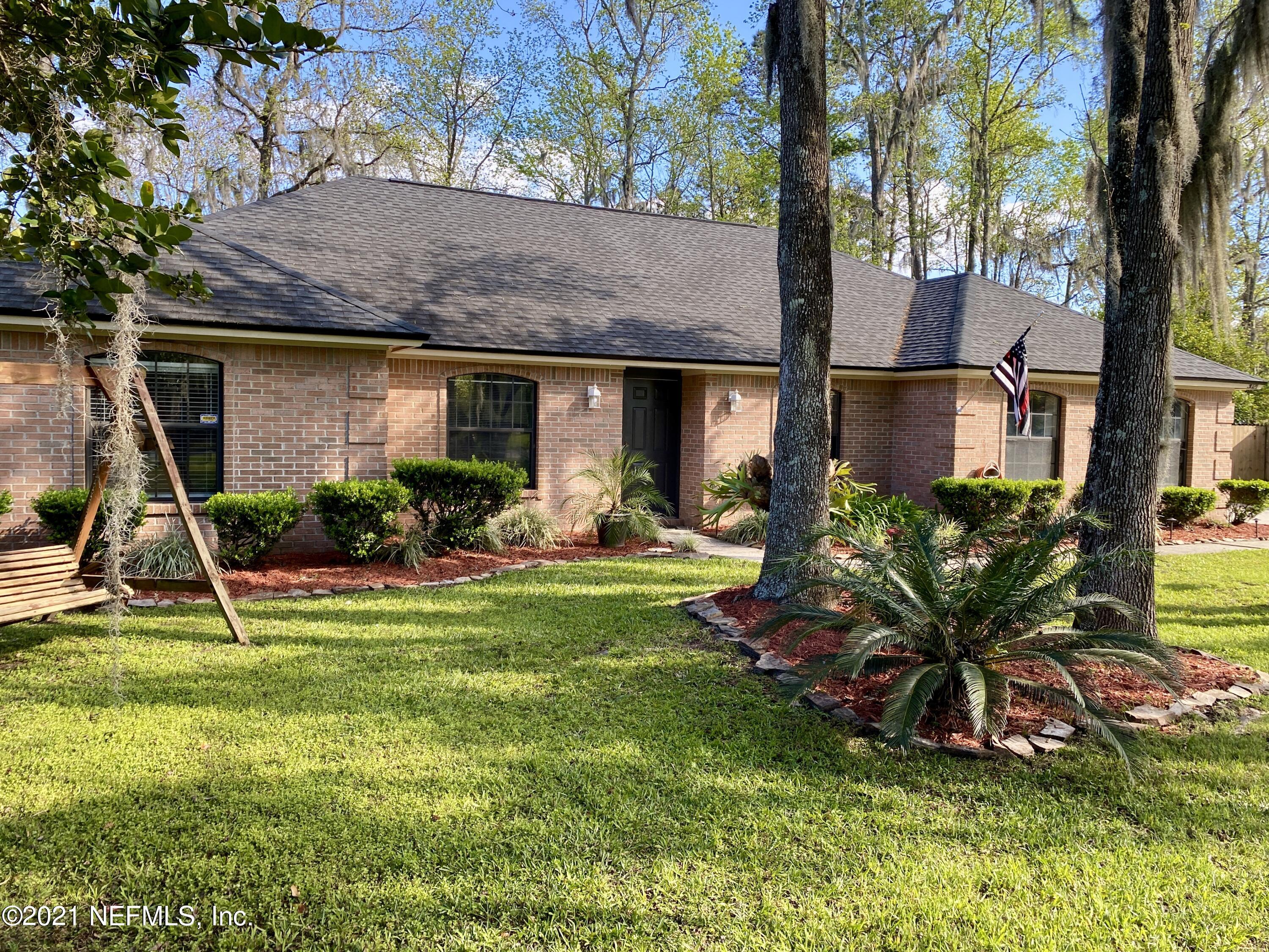 3021 Nautilus Road Middleburg, FL 32068 - Photo 2 of 25 a backyard of a house with table and chairs