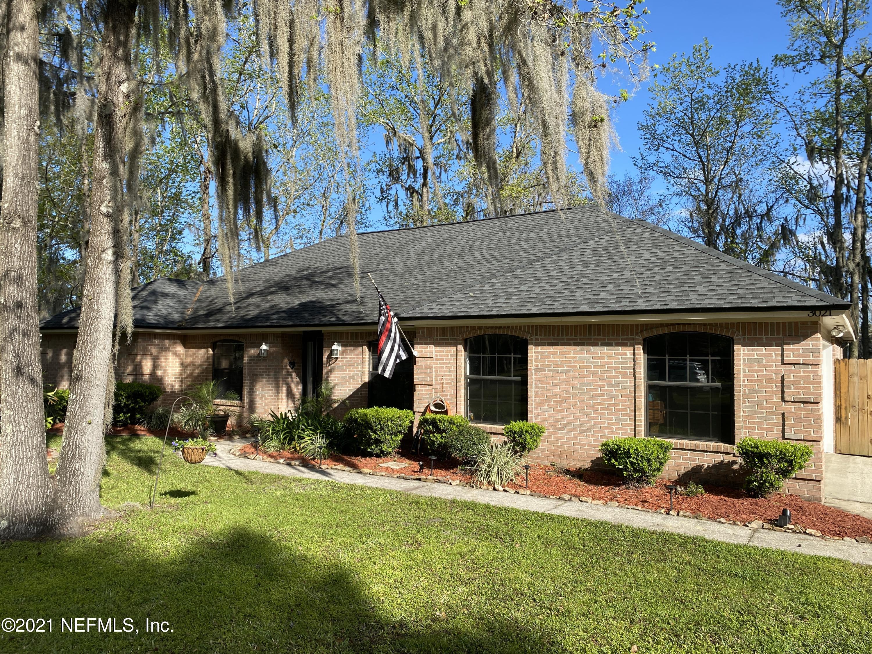 3021 Nautilus Road Middleburg, FL 32068 - Photo 3 of 25 a front view of house with yard and green space