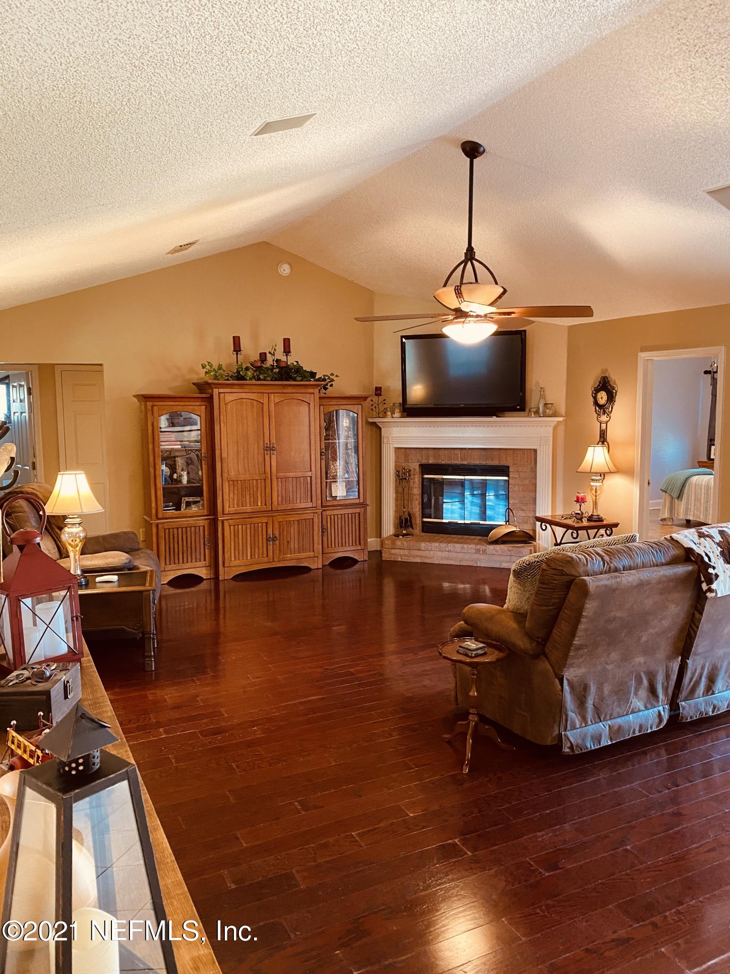 3021 Nautilus Road Middleburg, FL 32068 - Photo 6 of 25 a living room with furniture and a fireplace