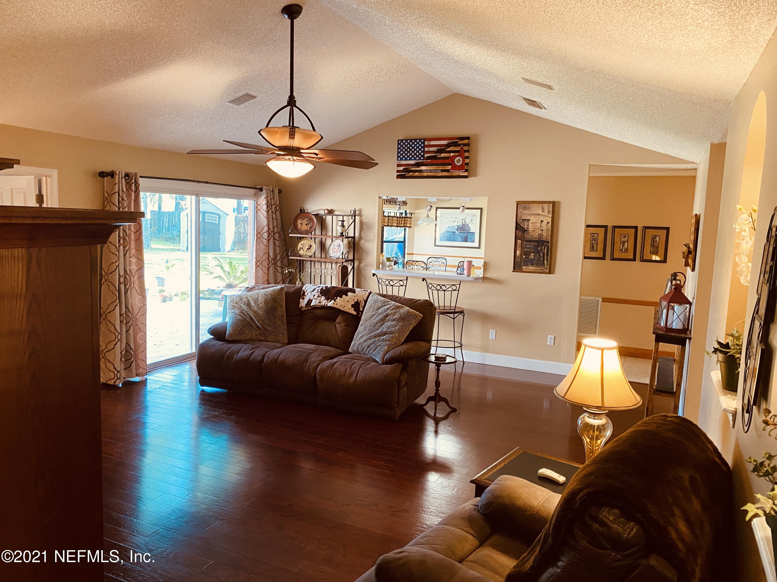 3021 Nautilus Road Middleburg, FL 32068 - Photo 7 of 25 a living room with furniture a ceiling fan and a window
