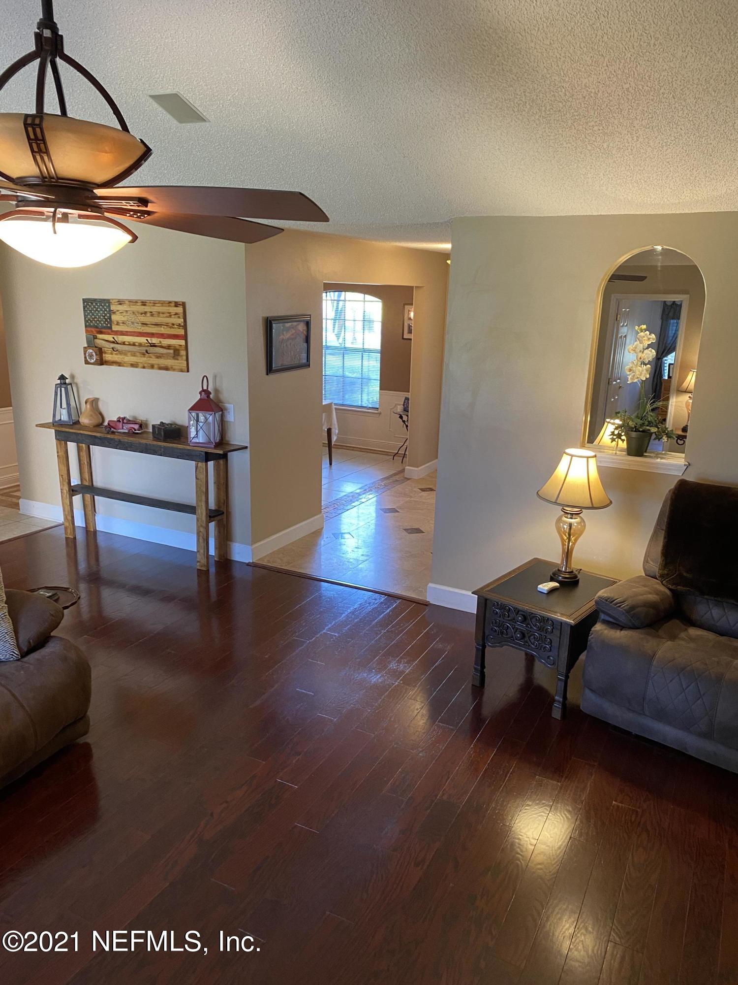 3021 Nautilus Road Middleburg, FL 32068 - Photo 9 of 25 a living room with furniture and wooden floor