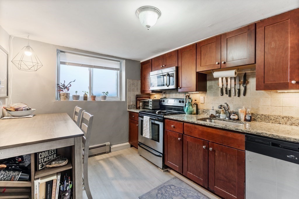 16 Bryon Road, Unit 2 Boston, MA 02467 - Photo 12 of 12 a kitchen with stainless steel appliances a sink stove and cabinets