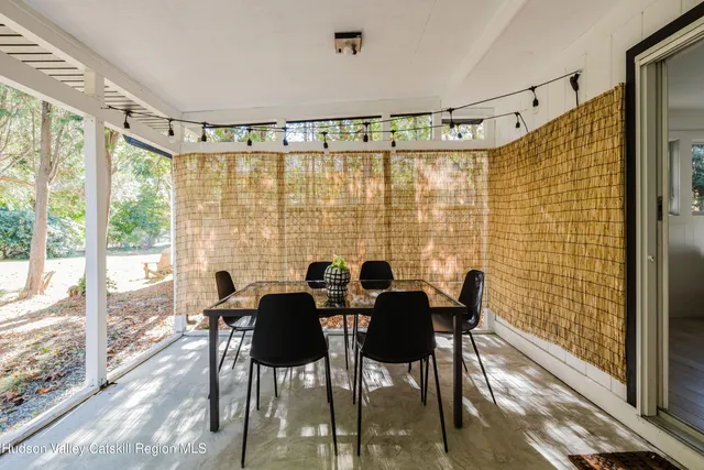 a view of a dining room with furniture and windows