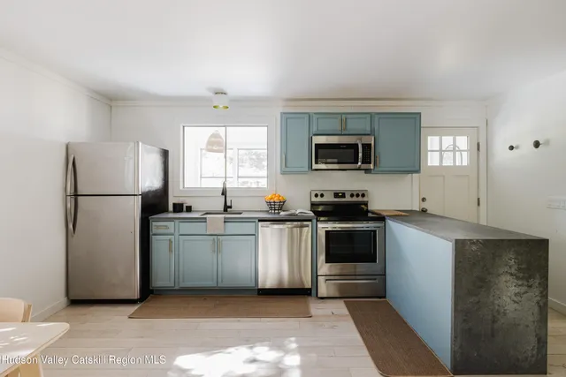 a kitchen with a refrigerator stove and microwave