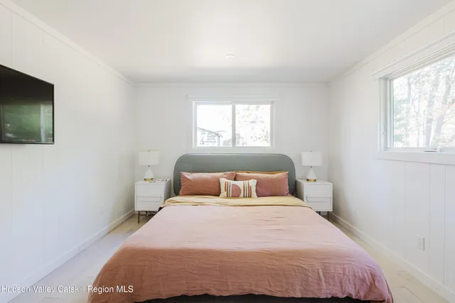 a bedroom with a bed and a flat screen tv