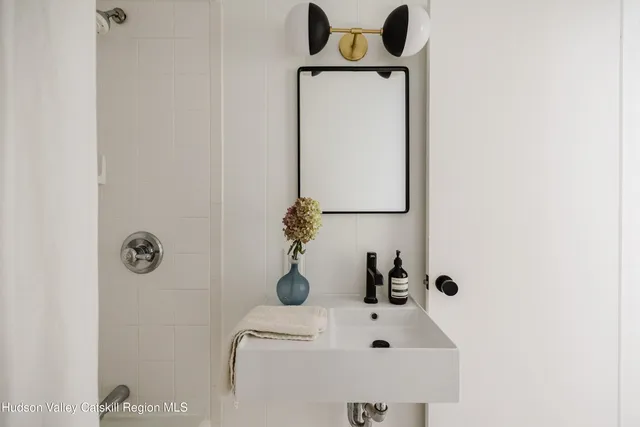a bathroom with a sink and mirror
