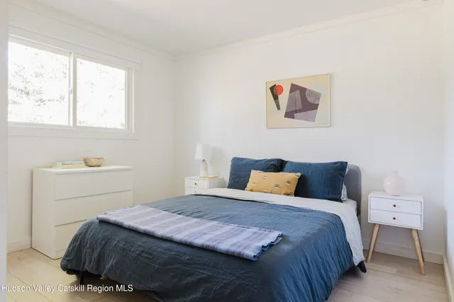a bedroom with a large bed and a window