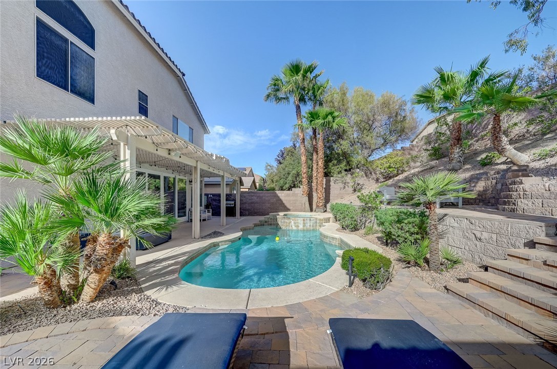 2391 Rainswept Avenue Henderson, NV 89052 - Photo 12 of 62 An inviting pool and patio area await, perfect for outdoor enjoyment.