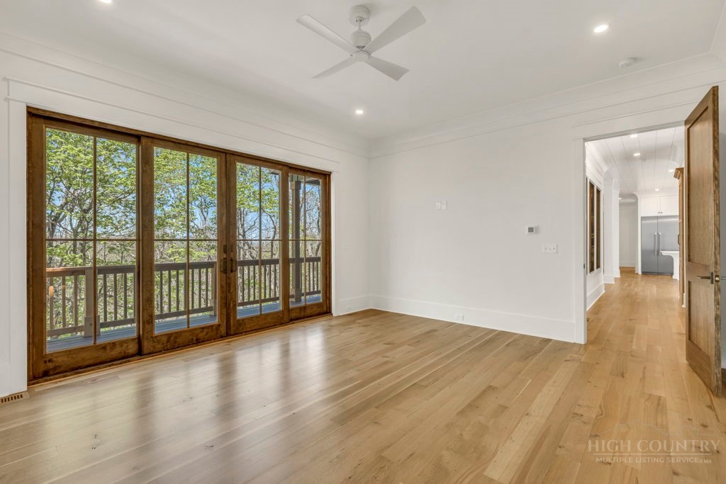 536 Boone Ridge Lane Boone, NC 28607 - Photo 26 of 50 a view of an empty room with wooden floor and a window