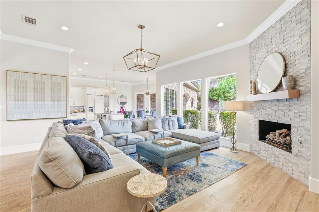 476 Hidden Valley Lane Coppell, TX 75019 - Photo 5 of 40 a living room with furniture a fireplace and a chandelier