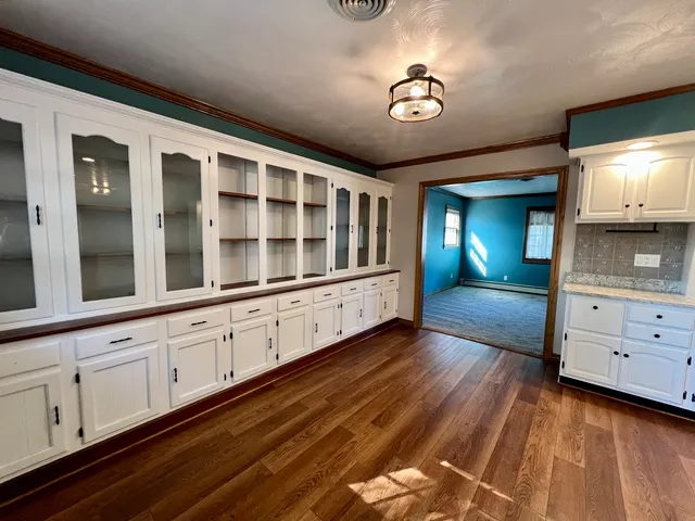 a large kitchen with stainless steel appliances kitchen island granite countertop a refrigerator and a stove