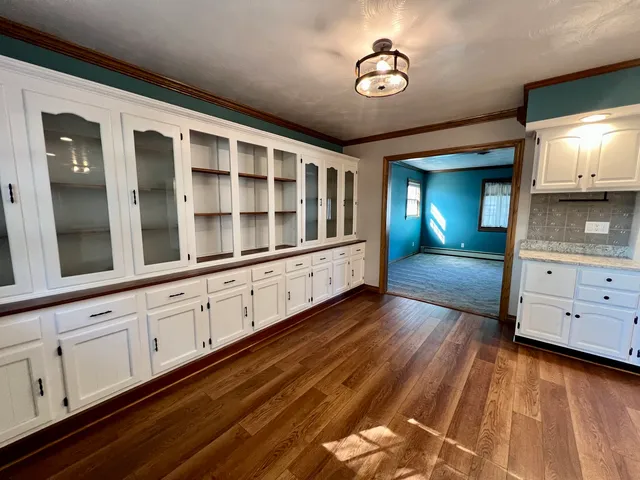 a large kitchen with stainless steel appliances granite countertop a large counter top a stove and a sink