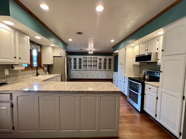 a view of an empty room with a fireplace and a window