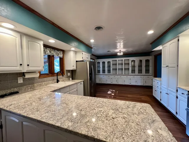 a view of an empty room with a fireplace and a window