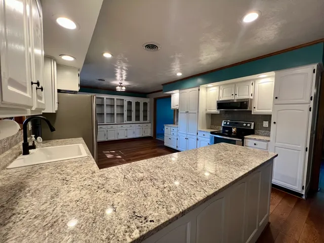 a view of an empty room with window and fire place