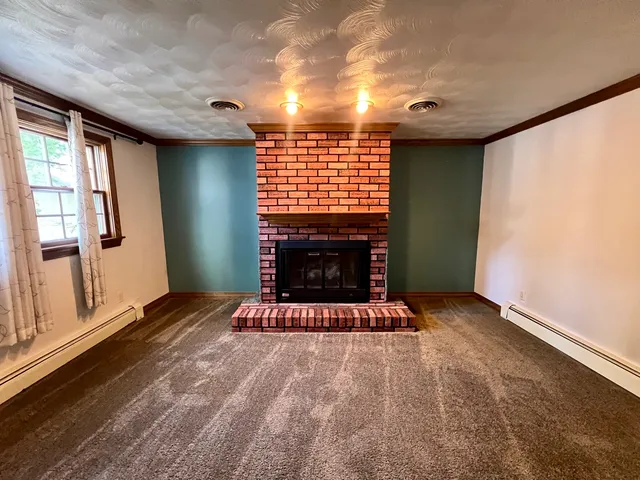 a view of a livingroom with a ceiling fan and window