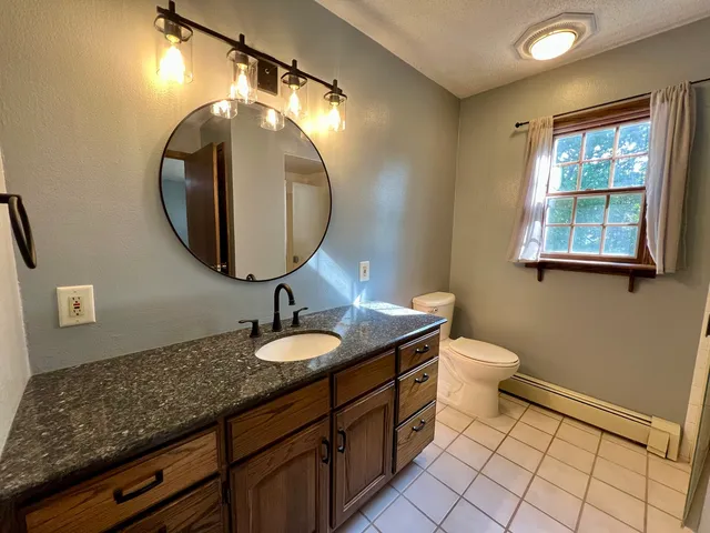 en empty room with windows and fan