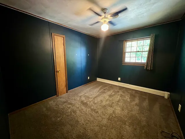 a bathroom with a granite countertop sink a toilet and a mirror