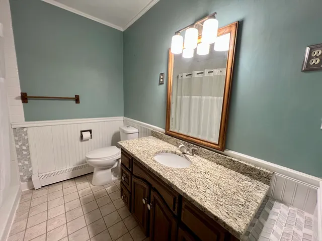 an empty room with closet and a chandelier fan