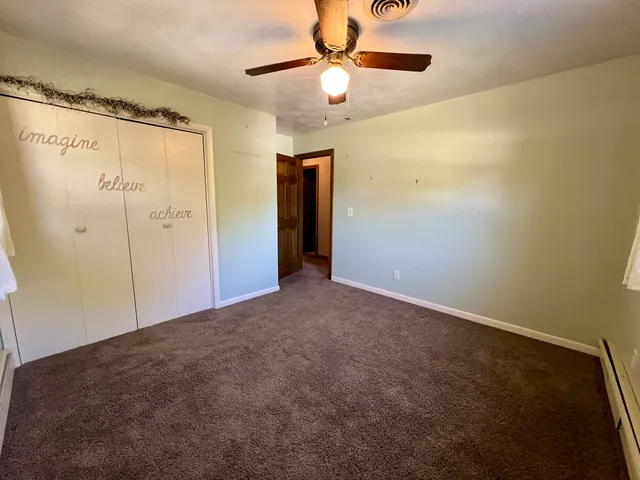 a view of a house with backyard and deck