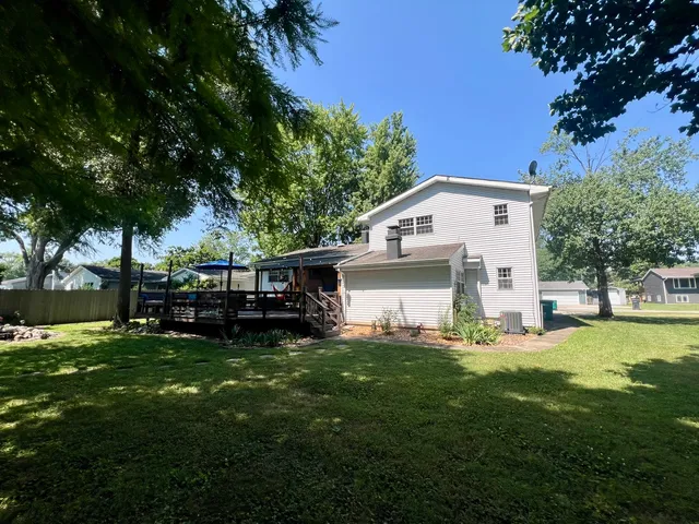 a view of a house with backyard and sitting area