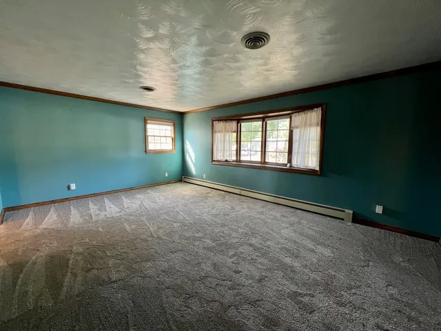 a view of empty room with window and fireplace