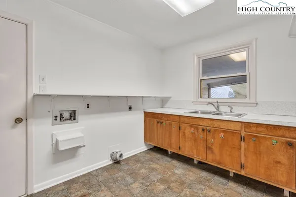 an empty room with wooden floor and a fireplace