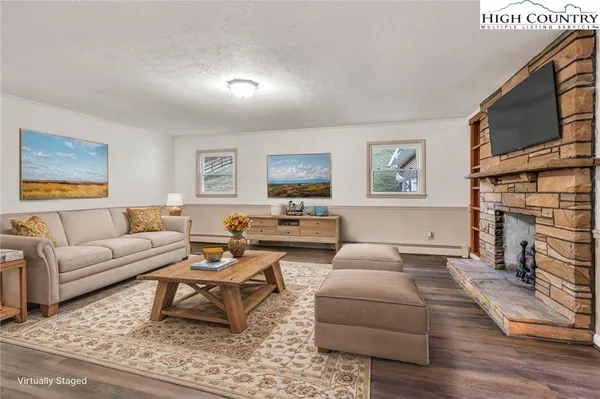 a living room with furniture and a fireplace