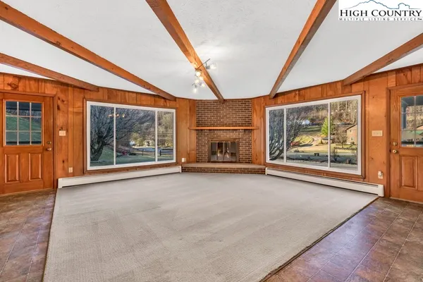 an empty room with furniture and a fireplace