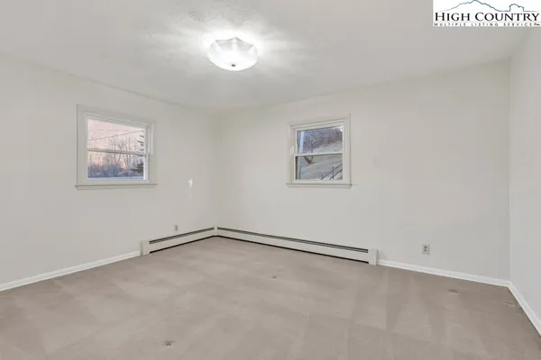 a bedroom with a bed and a potted plant