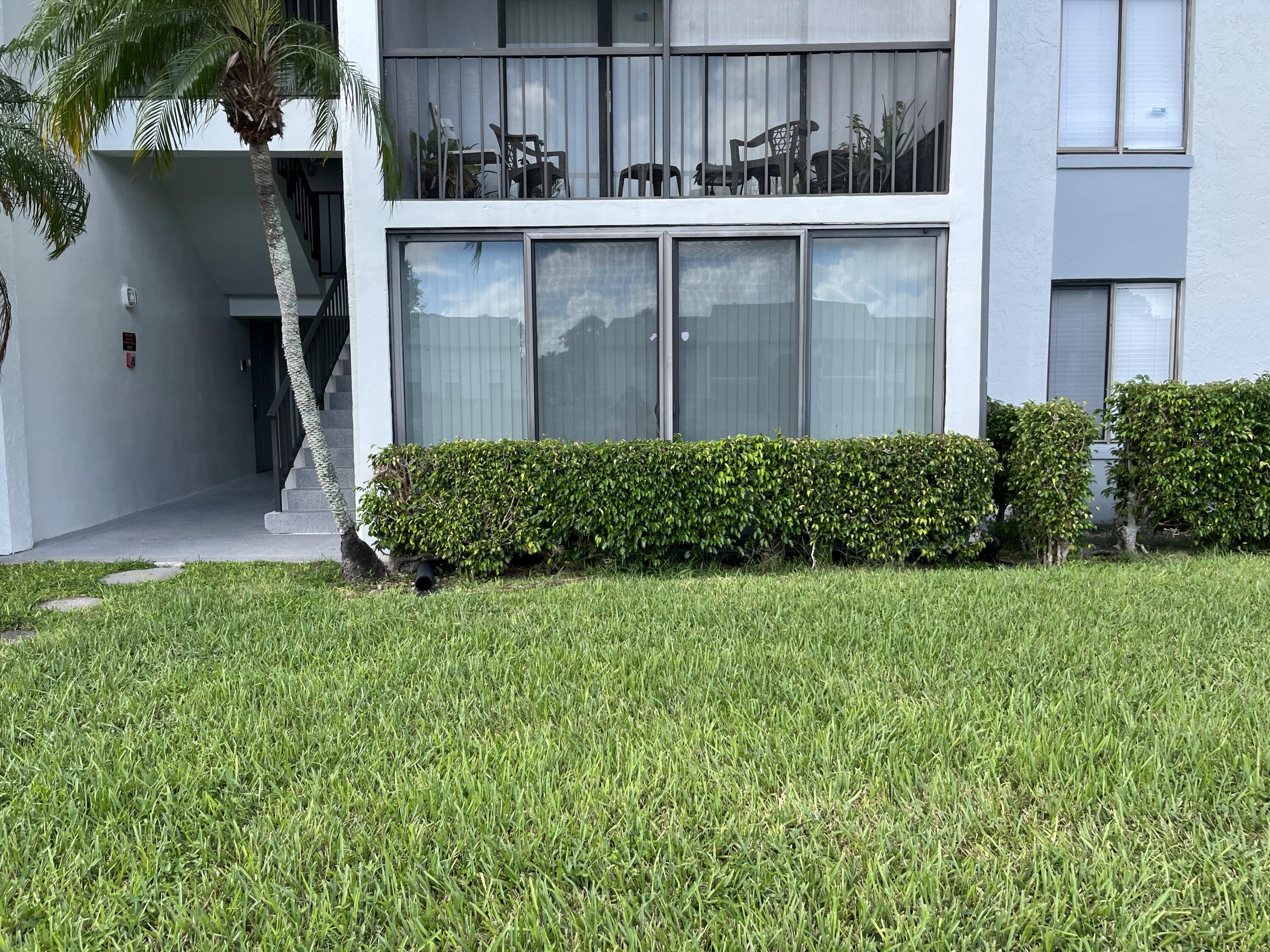 1012 Green Pine Boulevard, Unit B1 West Palm Beach, FL 33409 - Photo 1 of 13 a view of a backyard with plants
