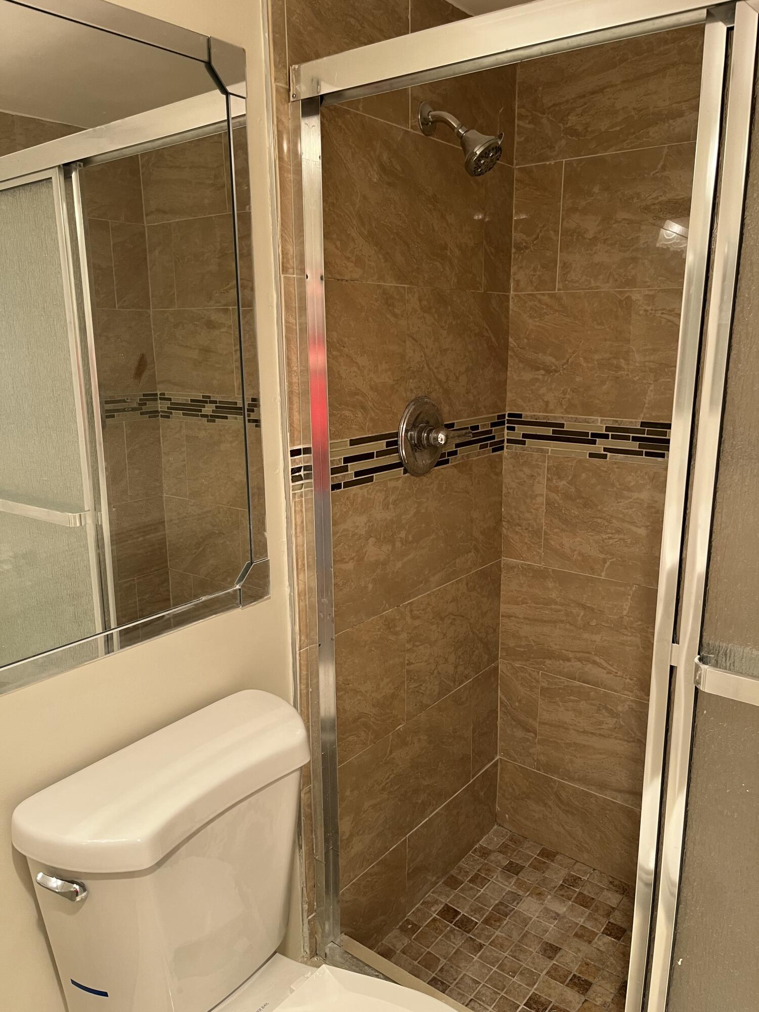 1012 Green Pine Boulevard, Unit B1 West Palm Beach, FL 33409 - Photo 13 of 13 a bathroom with a toilet and a shower