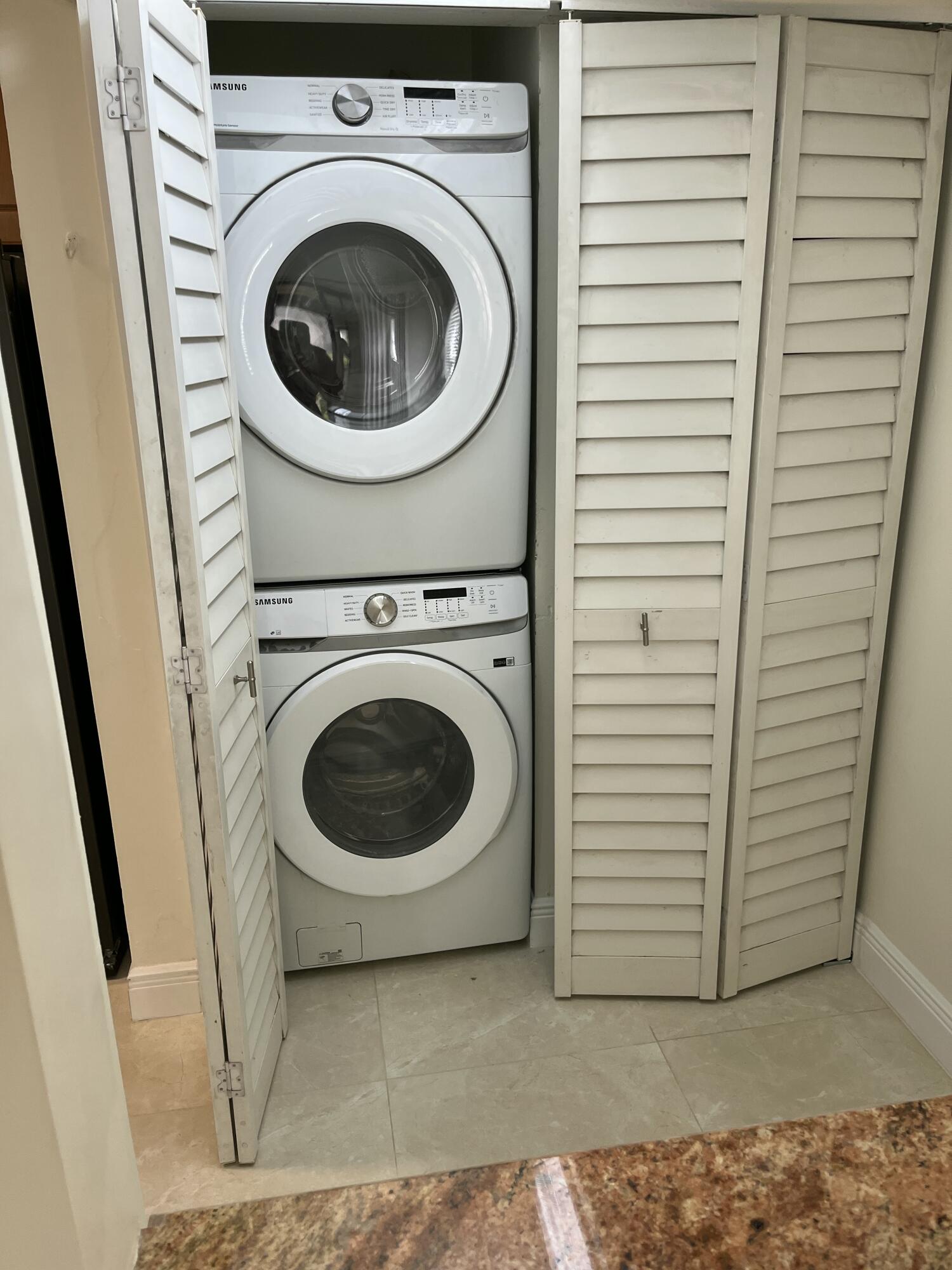 1012 Green Pine Boulevard, Unit B1 West Palm Beach, FL 33409 - Photo 4 of 13 a view of a hallway with washer and dryer