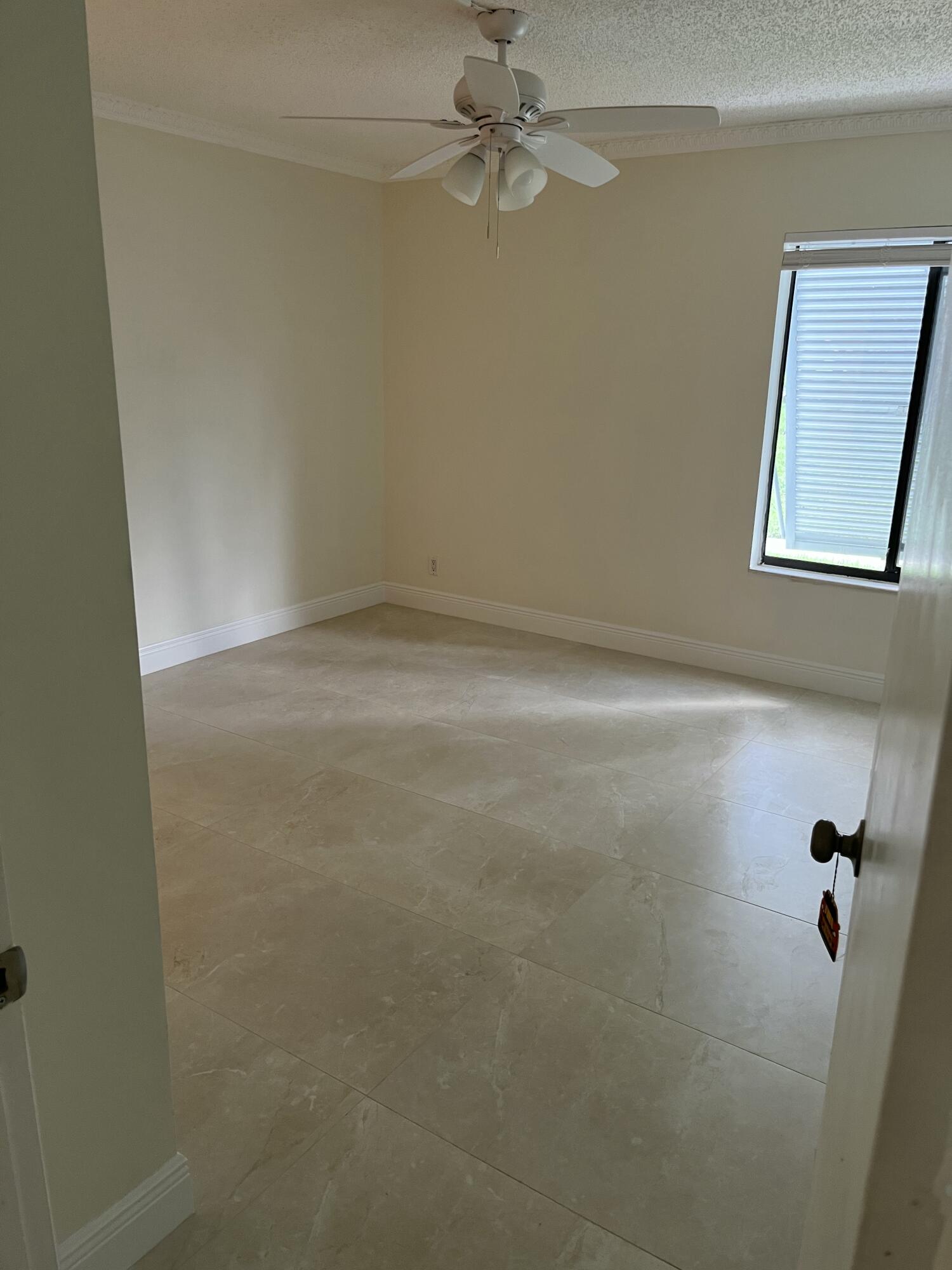1012 Green Pine Boulevard, Unit B1 West Palm Beach, FL 33409 - Photo 10 of 13 an empty room with a window