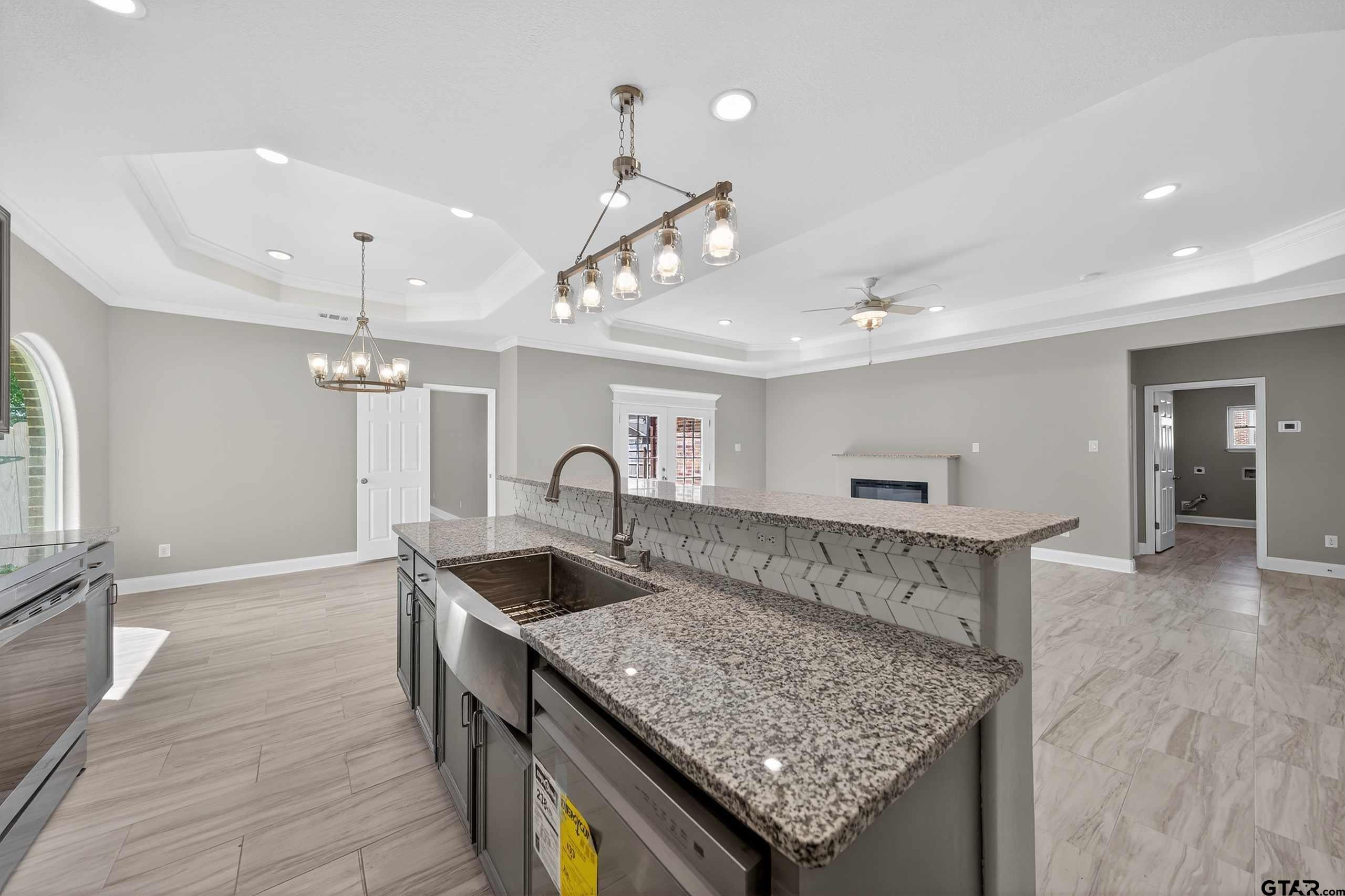 23001 Red Azalea Lane Lindale, TX 75771 - Photo 14 of 35 a kitchen with stainless steel appliances granite countertop a sink a counter space and wooden floor