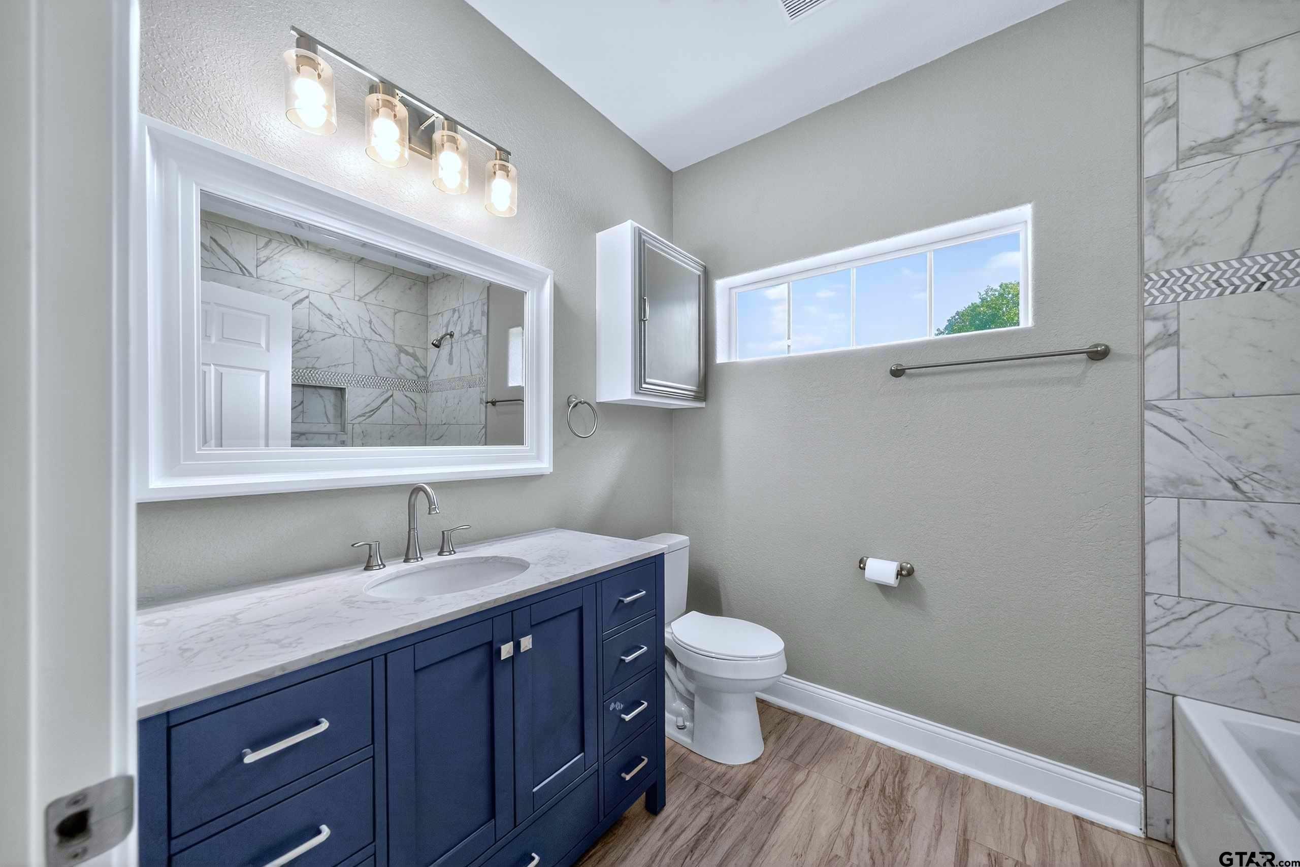 23001 Red Azalea Lane Lindale, TX 75771 - Photo 24 of 35 a bathroom with a toilet sink and mirror