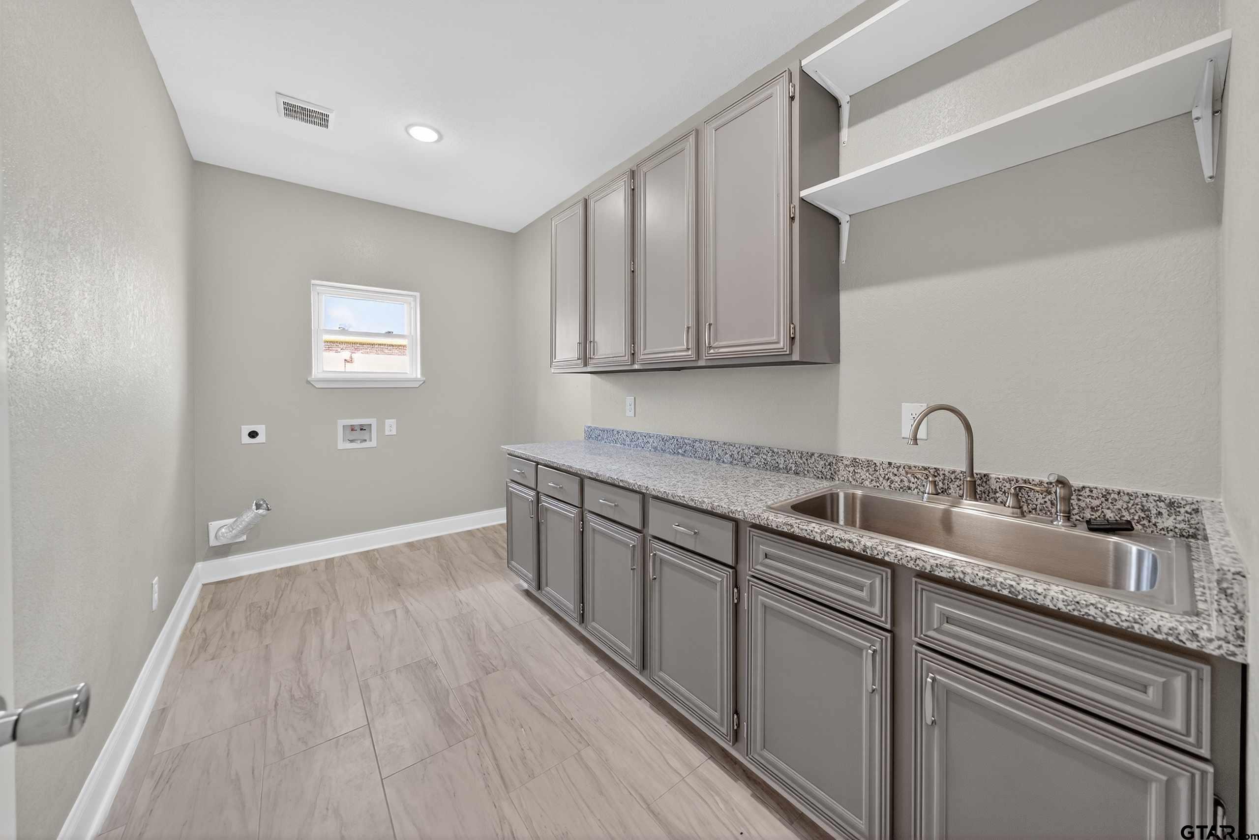 23001 Red Azalea Lane Lindale, TX 75771 - Photo 26 of 35 a kitchen with a sink and cabinets