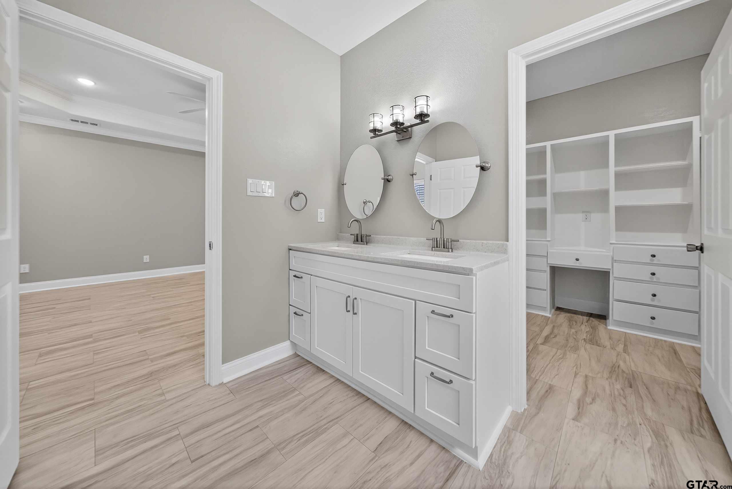 23001 Red Azalea Lane Lindale, TX 75771 - Photo 29 of 35 a spacious bathroom with a granite countertop sink a mirror and a vanity