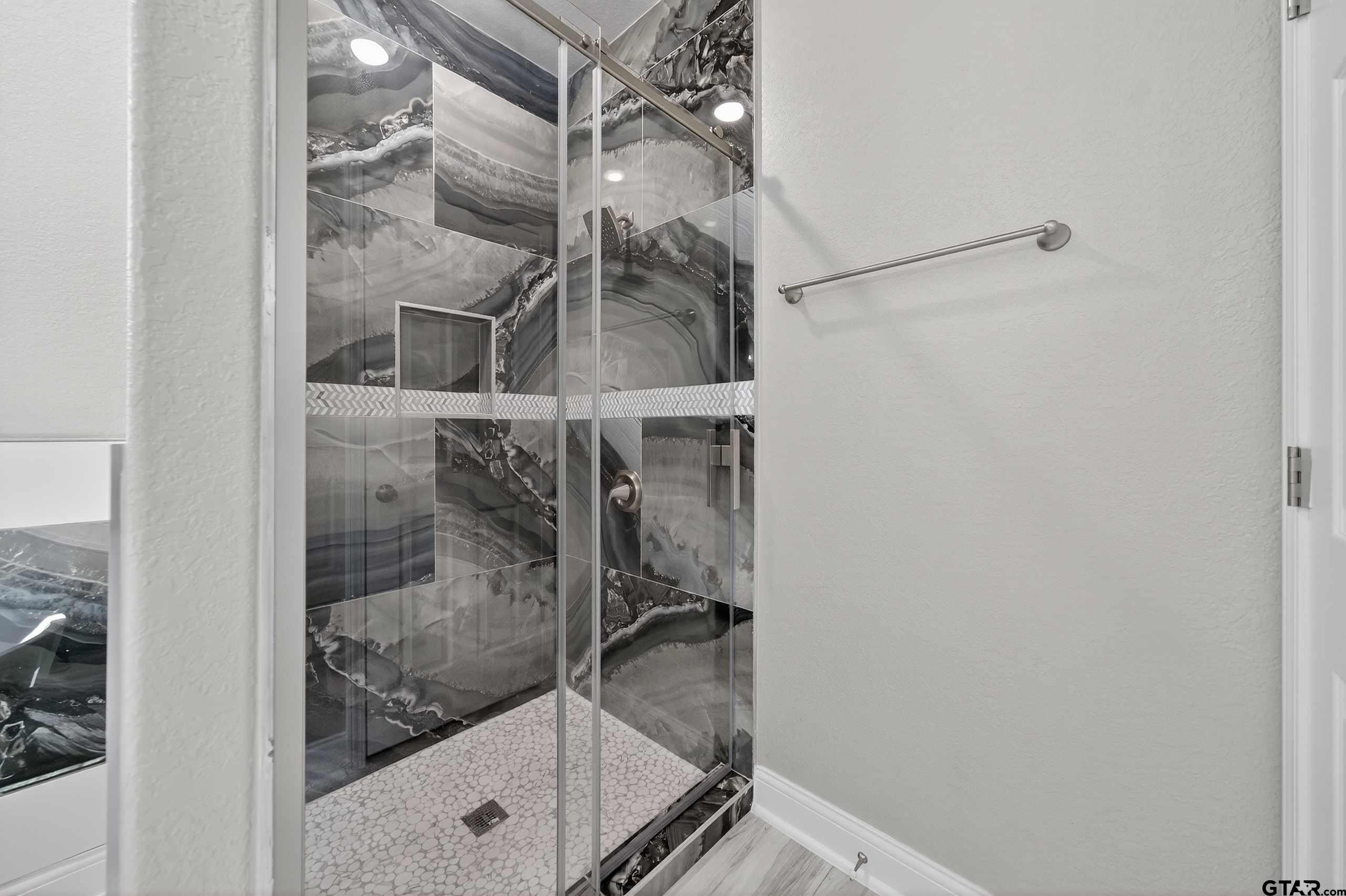 23001 Red Azalea Lane Lindale, TX 75771 - Photo 31 of 35 a bathroom with a glass shower door