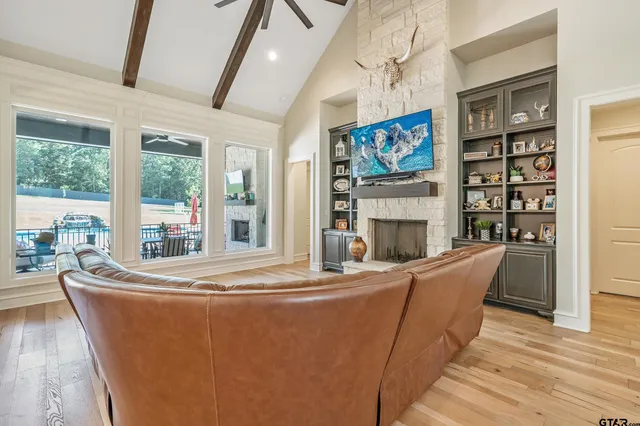 a living room with fireplace furniture and a floor to ceiling window