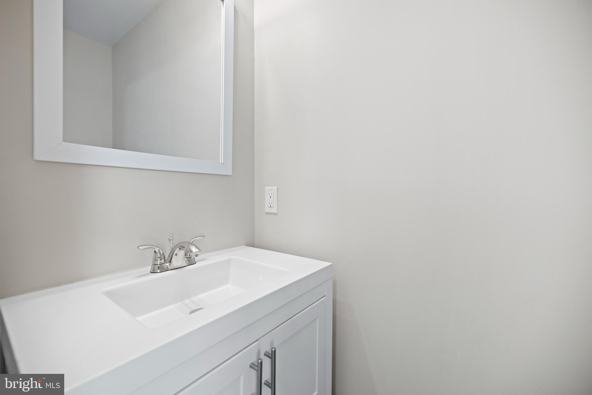 824 18th Street Northeast, Unit 11 Washington, DC 20002 - Photo 12 of 17 a bathroom with a sink and a mirror