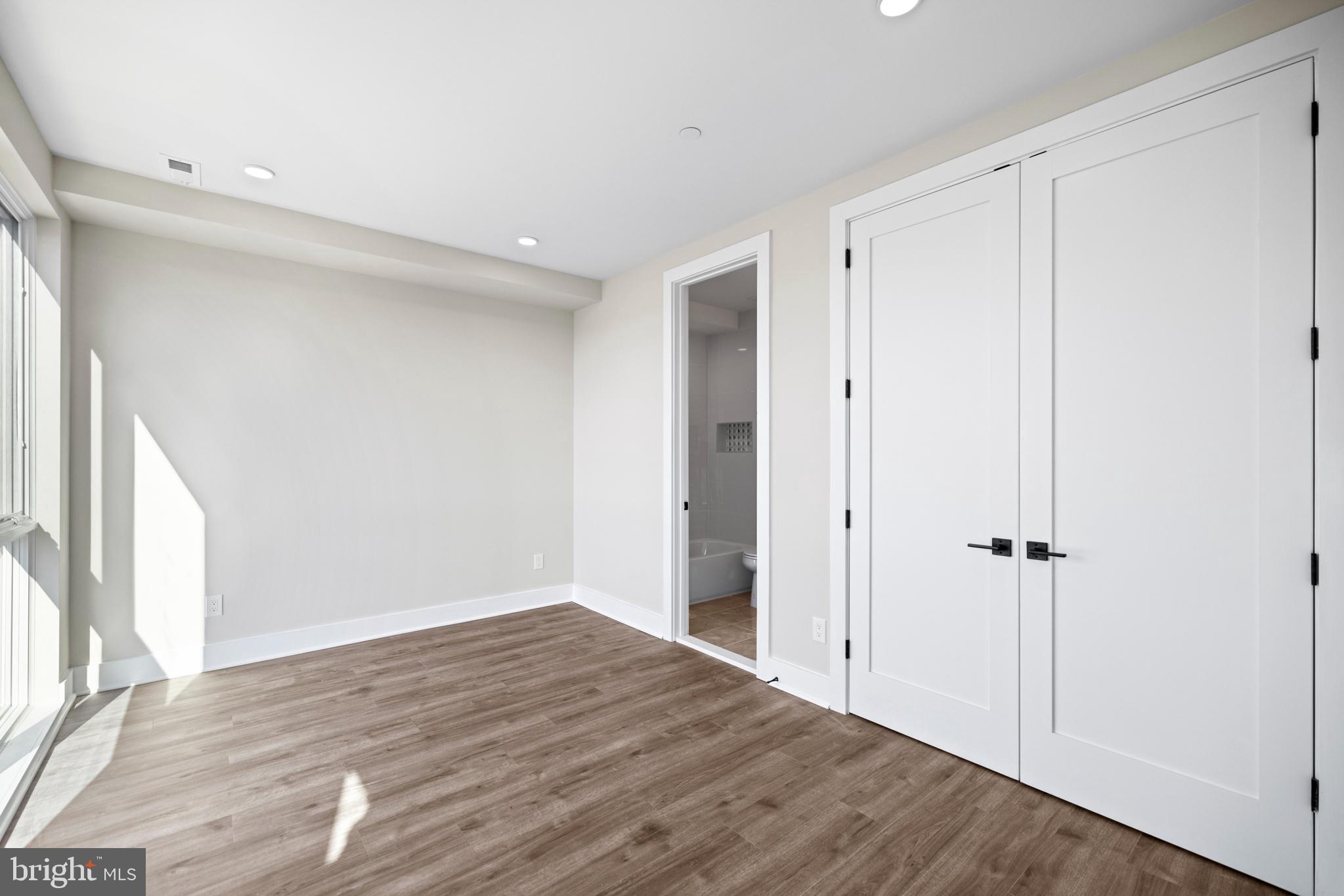 824 18th Street Northeast, Unit 11 Washington, DC 20002 - Photo 13 of 17 an empty room with wooden floor and a window