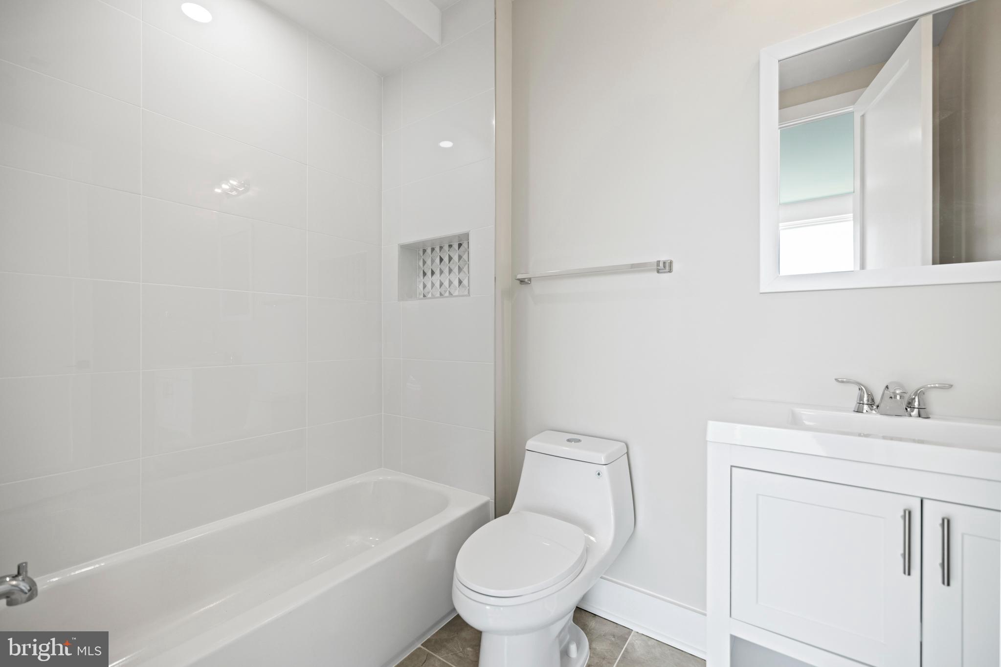 824 18th Street Northeast, Unit 11 Washington, DC 20002 - Photo 15 of 17 a bathroom with a sink toilet and vanity