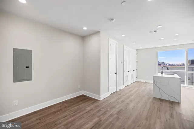 a view of an empty room with wooden floor