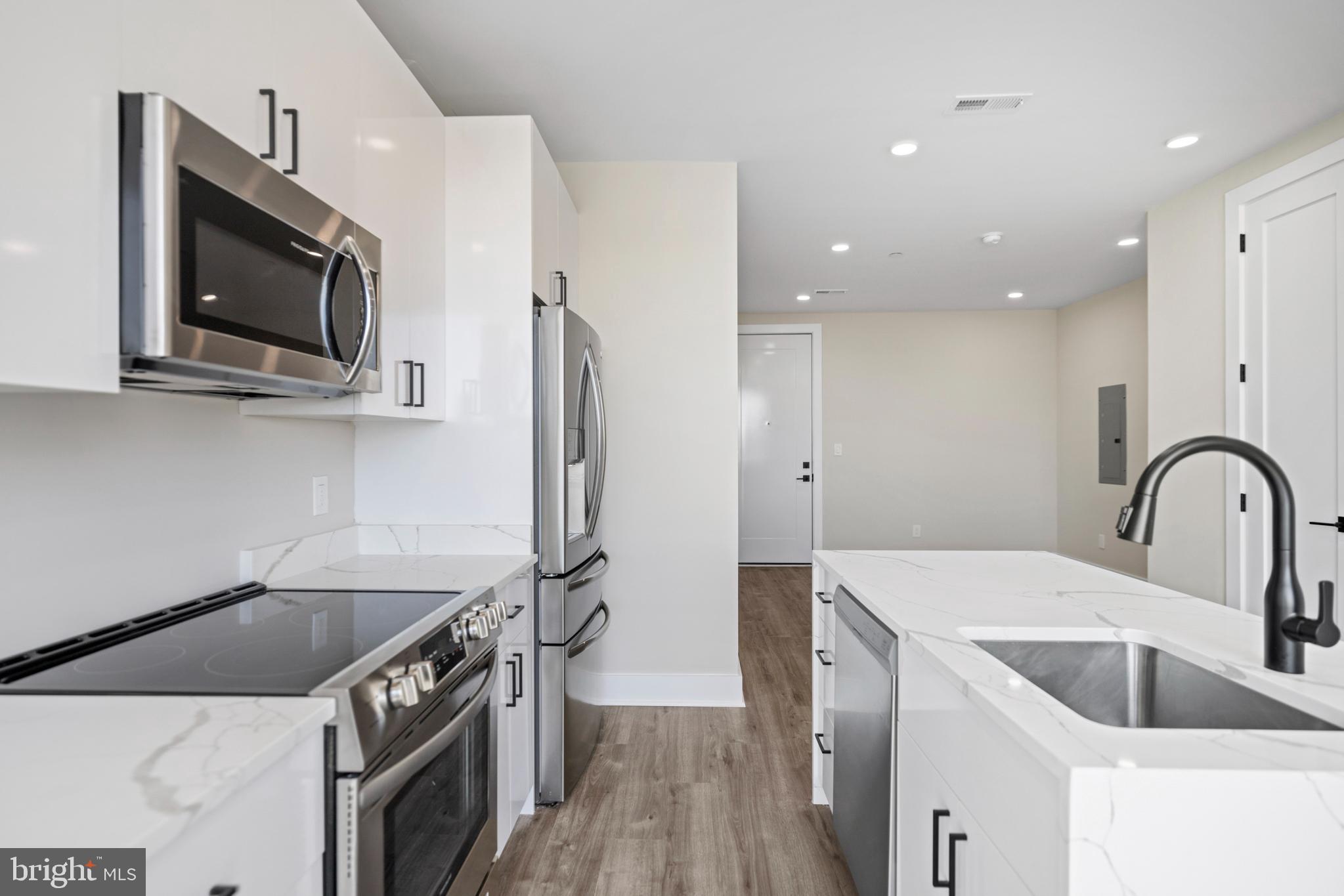 824 18th Street Northeast, Unit 11 Washington, DC 20002 - Photo 9 of 17 a kitchen with stainless steel appliances granite countertop a sink a stove and a refrigerator