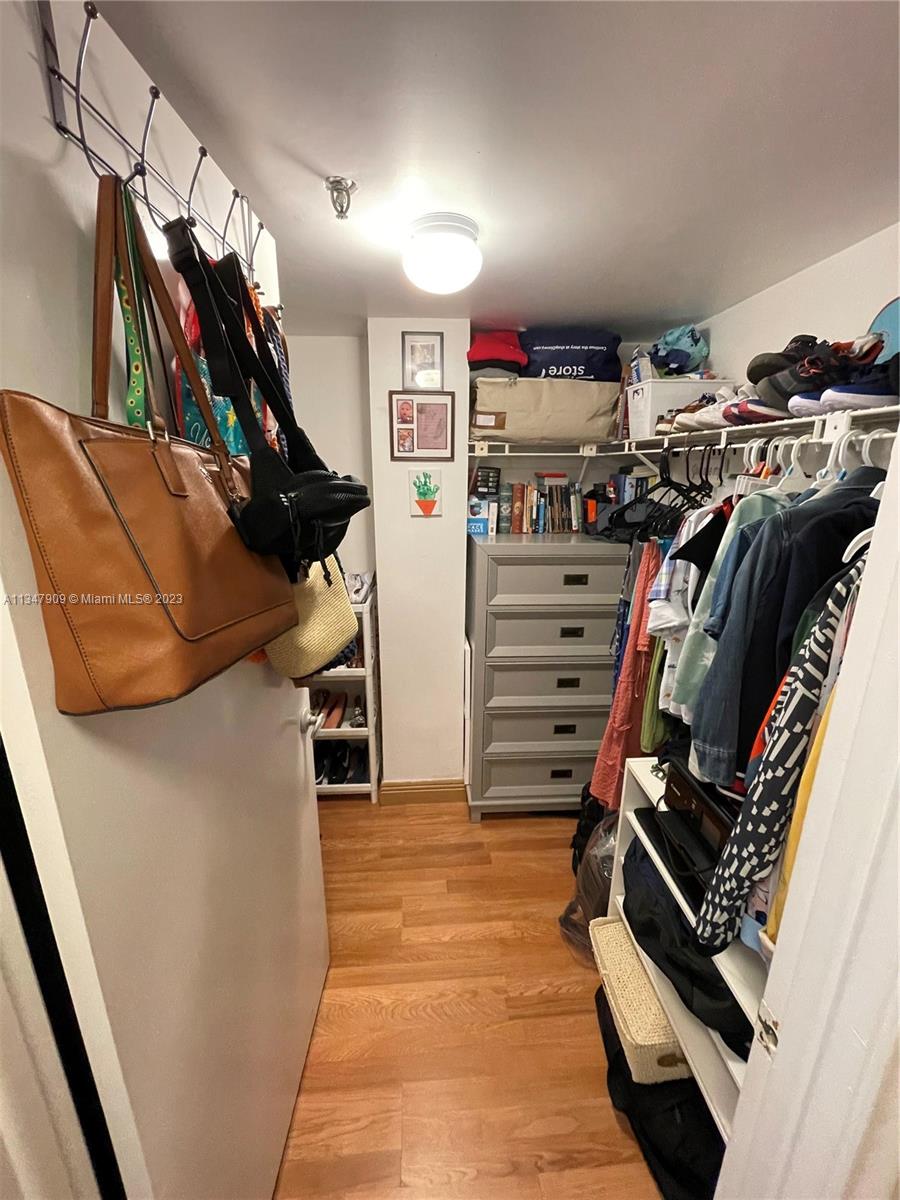 Ives Estates Miami, FL 33179 - Photo 12 of 34 a view of walk in closet with clothes and shoes